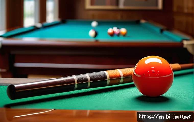 초보자를 위한 당구 장비 추천 - A close-up shot of a high-quality maple pool cue resting on a polished wooden floor beside a set of ...